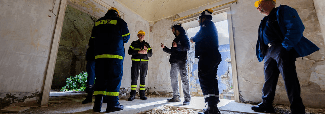 Staff in field discussing adjustments