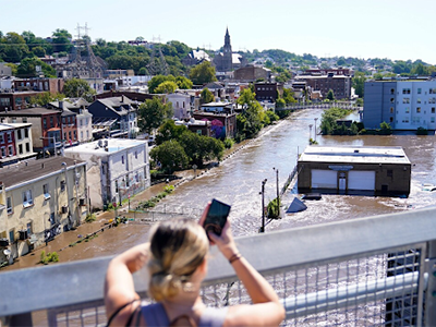 girl taking photo of flooding