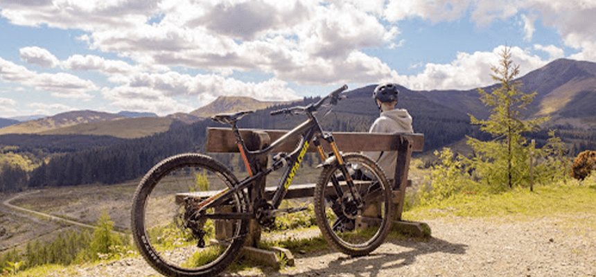 kid sitting on park bench looking at mountains