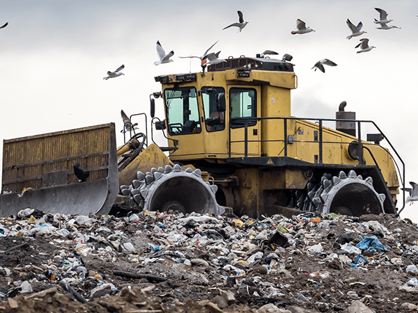 Tractor removing solid waste